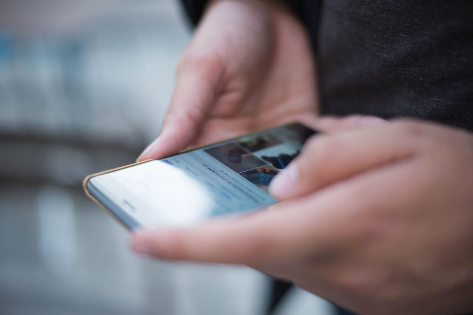Hands holding a phone, searching online
